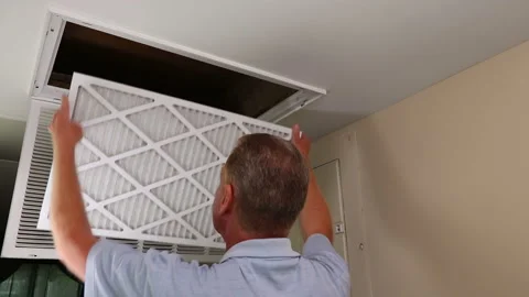 Replacing Dirty Air Filter with a Clean Air Filter in Ceiling Furnace Stock Footage 188175625