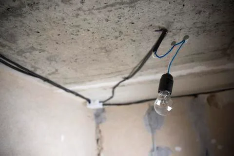 Replacing the electric lamp on the ceiling Stock Photos