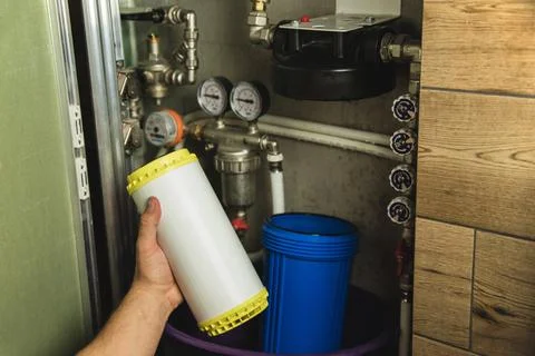 Replacing the filter element in the home water purification system close-up Stock Photos