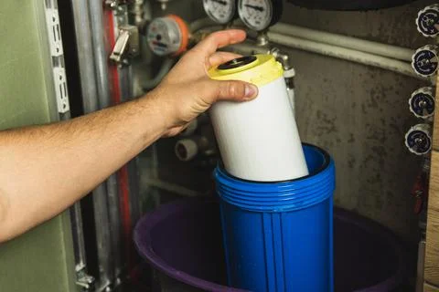 Replacing the filter element in the home water purification system close-up Stock Photos