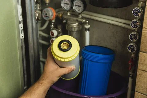 Replacing the filter element in the home water purification system close-up Stock Photos