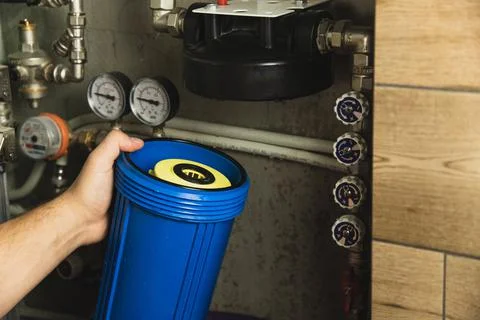 Replacing the filter element in the home water purification system close-up Stock Photos