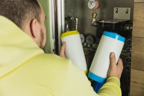 Replacing the filter element in the home water purification system close-up Stock Photos