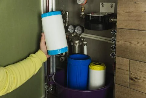 Replacing the filter element in the home water purification system close-up Stock Photos