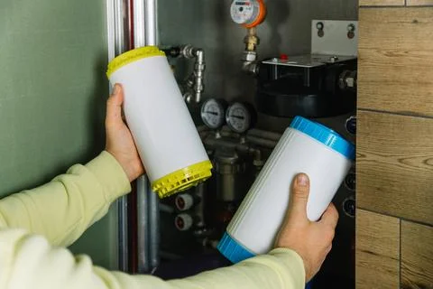 Replacing the filter element in the home water purification system close-up Stock Photos