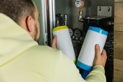Replacing the filter element in the home water purification system close-up Stock Photos