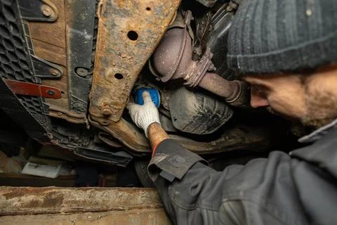 Replacing the filter in the oil filter in the car. A man is changing the oil Stock Photos