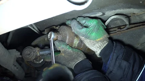 Replacing the fuel filter in the car. A station worker repairs a car. Stock Footage 121998408