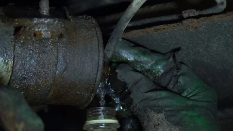Replacing the fuel filter in the car. A station worker repairs a car. Stock Footage 121998457