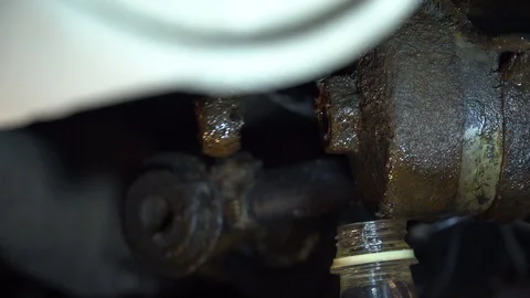Replacing the fuel filter in the car. A station worker repairs a car. Stock Footage 121998495
