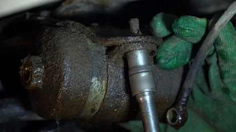 Replacing the fuel filter in the car. A station worker repairs a car. Stock Footage 121998503