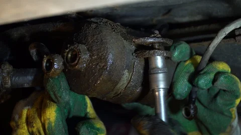 Replacing the fuel filter in the car. A station worker repairs a car. Stock Footage 121998608