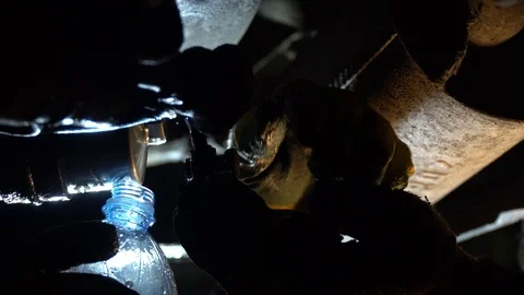 Replacing the fuel filter in the car. A station worker repairs a car. Stock Footage 121998751