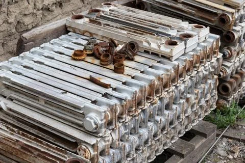 Replacing heating radiators: a stack of old cast iron radiators prepared for  Foto stock