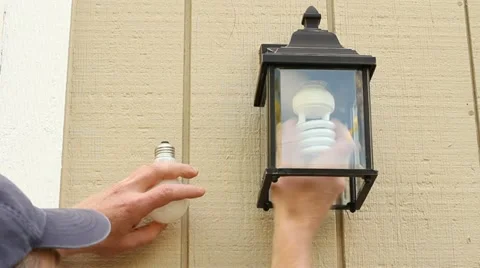 Replacing Incandescent Bulb with a CFL Stock Footage 11408050