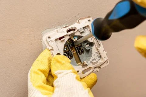 Replacing, installing an electrical socket, outlet with hands in protective r Stock Photos