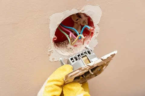 Replacing, installing an electrical socket, outlet with hands in protective r Stock Photos