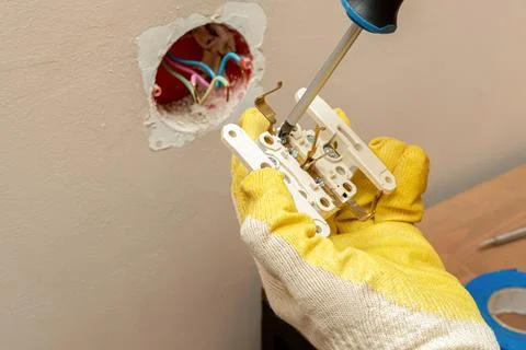 Replacing, installing an electrical socket, outlet with hands in protective r Foto stock