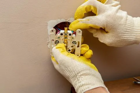 Replacing, installing an electrical socket, outlet with hands in protective r Stock Photos