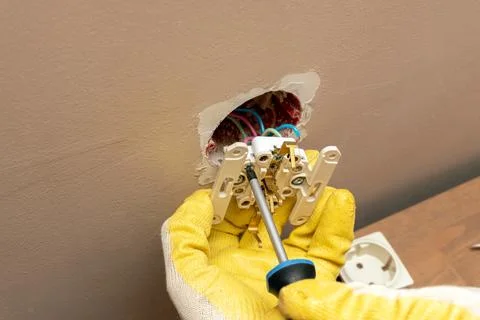 Replacing, installing an electrical socket, outlet with hands in protective r Foto stock
