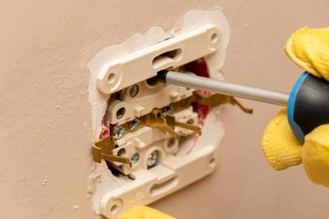 Replacing, installing an electrical socket, outlet with hands in protective r Stock Photos