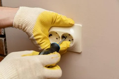 Replacing, installing an electrical socket, outlet with hands in protective r Stock Photos