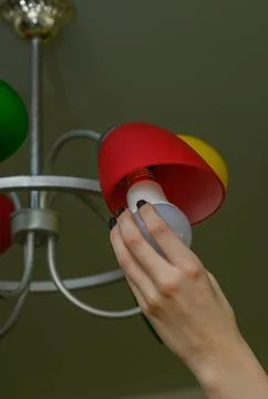 Replacing the light bulb in the lamp Stock Photos