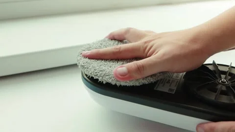 Replacing the microfiber on the window cleaner robot with a clean one. State of Stock Footage 253470945