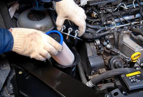 Replacing a new fuel filter on a modern car to clean the fuel from dirt. Close 스톡 사진