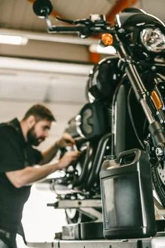 Replacing the oil in a motorcycle. Stock Photos