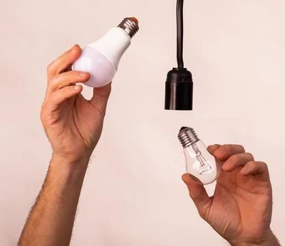 Replacing an old lamp with an LED one Stock Photos