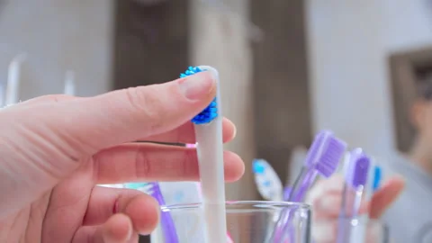 Replacing old toothbrush with a new one Stock Footage 143623610