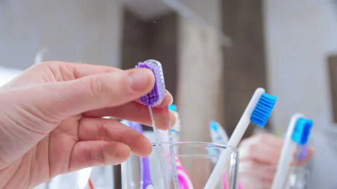 Replacing old toothbrush with a new one Stock Footage 144183907