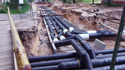 Replacing old underground hot water heating pipes with new ones. Excavation of Stock-Footage 300868928