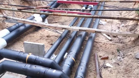 Replacing old underground hot water heating pipes with new ones. Excavation of Stock Footage 300868989