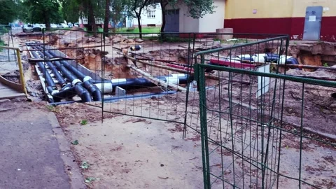 Replacing old underground hot water heating pipes with new ones. Excavation of Stock Footage 300869031