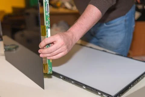 Replacing the screen in a modern LCD TV with LED backlight in the service Stock Photos