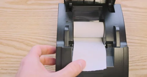 Replacing the thermal paper roll in a receipt printer. First person view, hands Video stock 214304468
