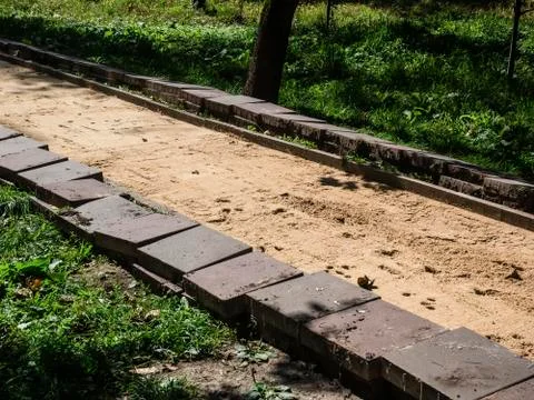 Replacing tiles on the path in the Park in the summer Stock Photos
