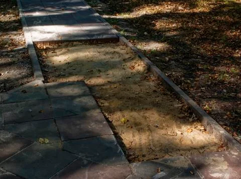Replacing tiles on the path in the Park in the summer Stock Photos