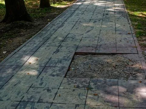 Replacing tiles on the path in the Park in the summer Stock Photos