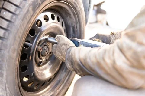Replacing the wheel on the car. Stock Photos