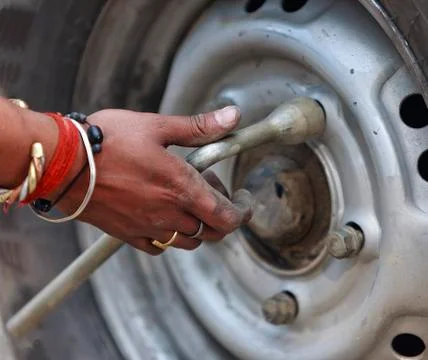Replacing the wheels of the car on the road Stock Photos
