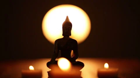 Replica of Buddha statue and moving candle flames Stock Footage 45955335