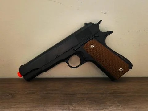 Replica of a gun with an orange tip Stock Photos