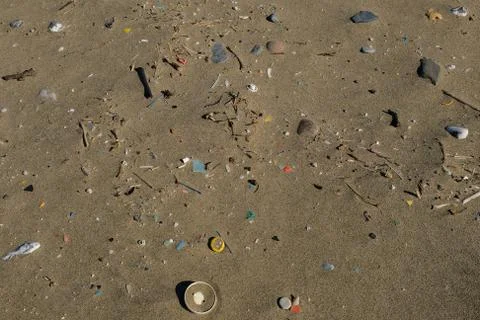 Report shot of plastic garbage on sandy sea coast Stock Photos