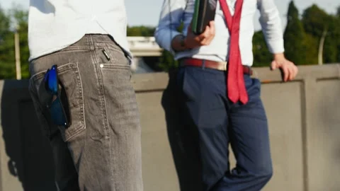A reporter with his assistant prepares for an interview in the street Video stock 153244965
