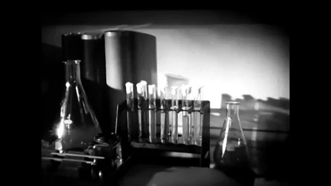 A reporter interviews a scientist in a laboratory about plastics, in 1937. Stock Footage