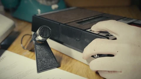 Reporter sets up Desktop microphone for retro analogue tape recording Stock Footage 308629702