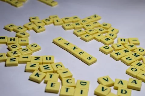 Representation of few letter blocks in which taxes are highlighted Stock Photos